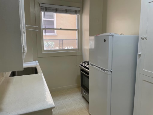 a kitchen with a refrigerator and a window